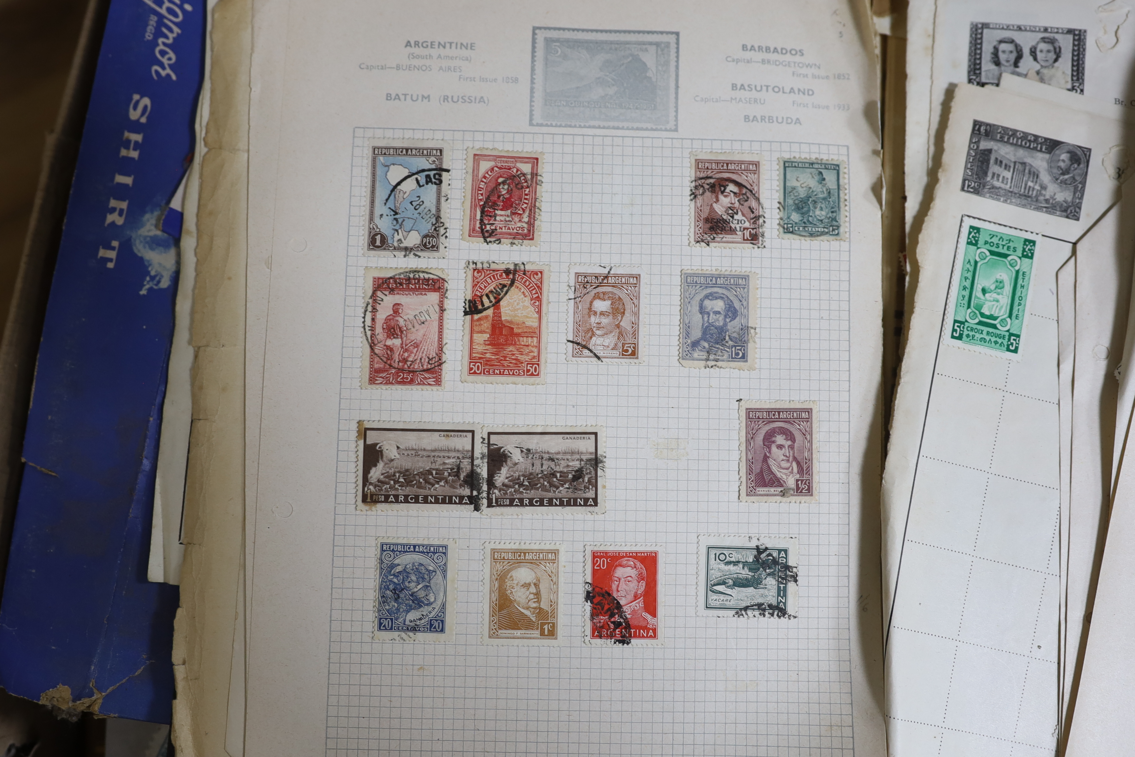 A collection of world stamps, some arranged in albums